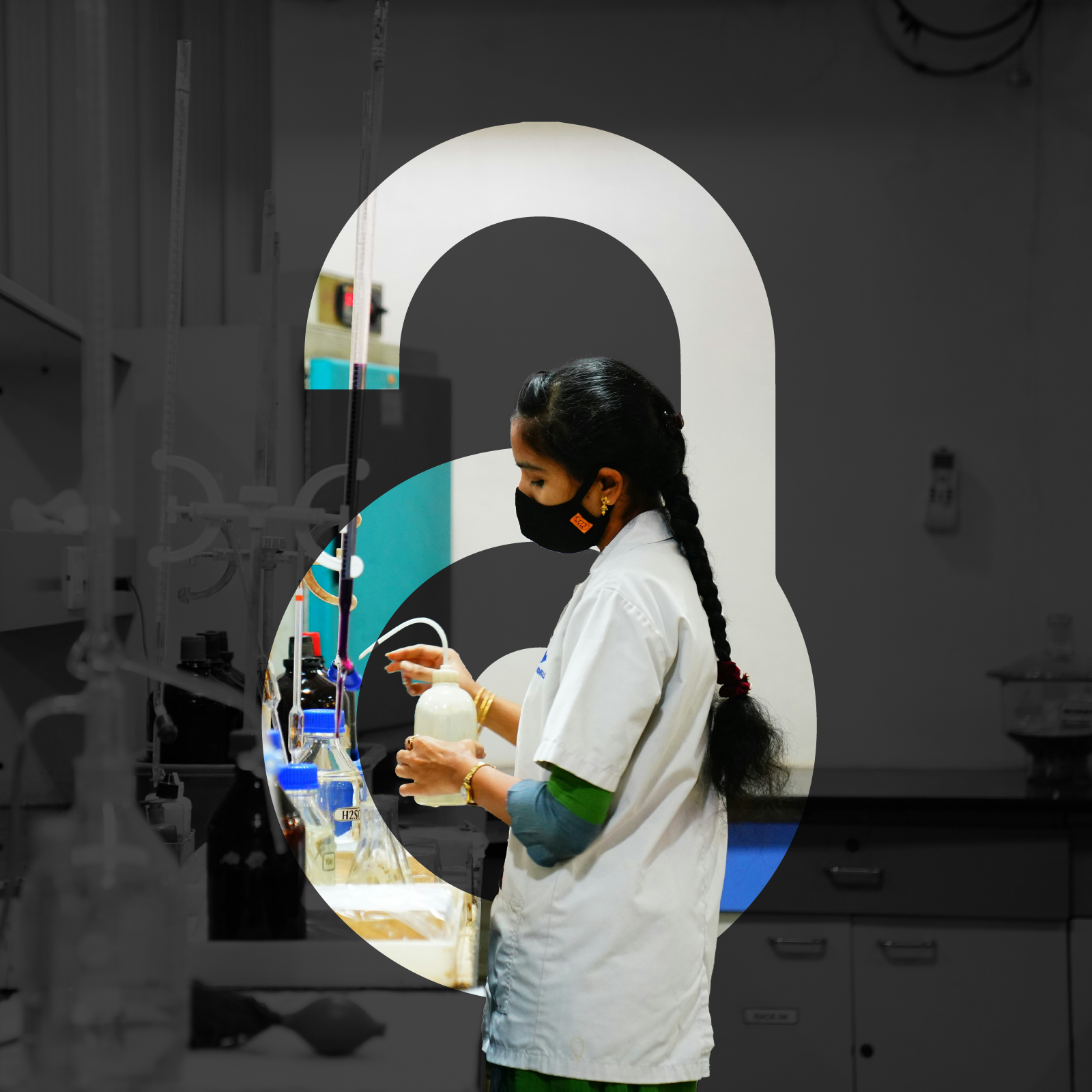 A female scientist with long, black hair and wearing a white lab coat and black face mask works with equipment in a laboratory. The open access “unlock” symbol overlays the image. Only the scientist and open access symbol are shown in color, the rest of the image is in black and white.